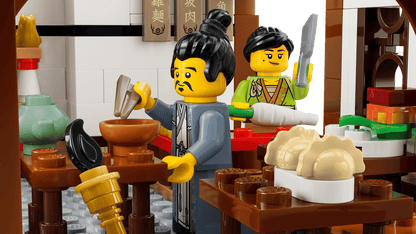 LEGO figures in a kitchen setting with various kitchen items and utensils.