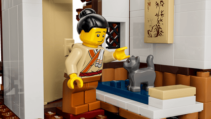 LEGO figure in a kitchen setting with a cat on a counter