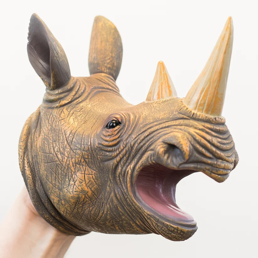 A realistic rhinoceros head puppet being worn on a hand, shown against a plain white background.