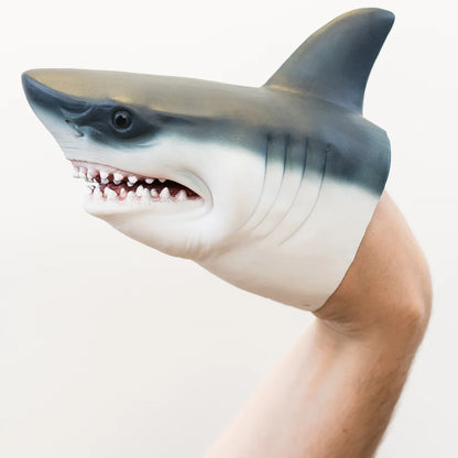 A shark-shaped puppet worn on a person's arm, shown against a plain light background.