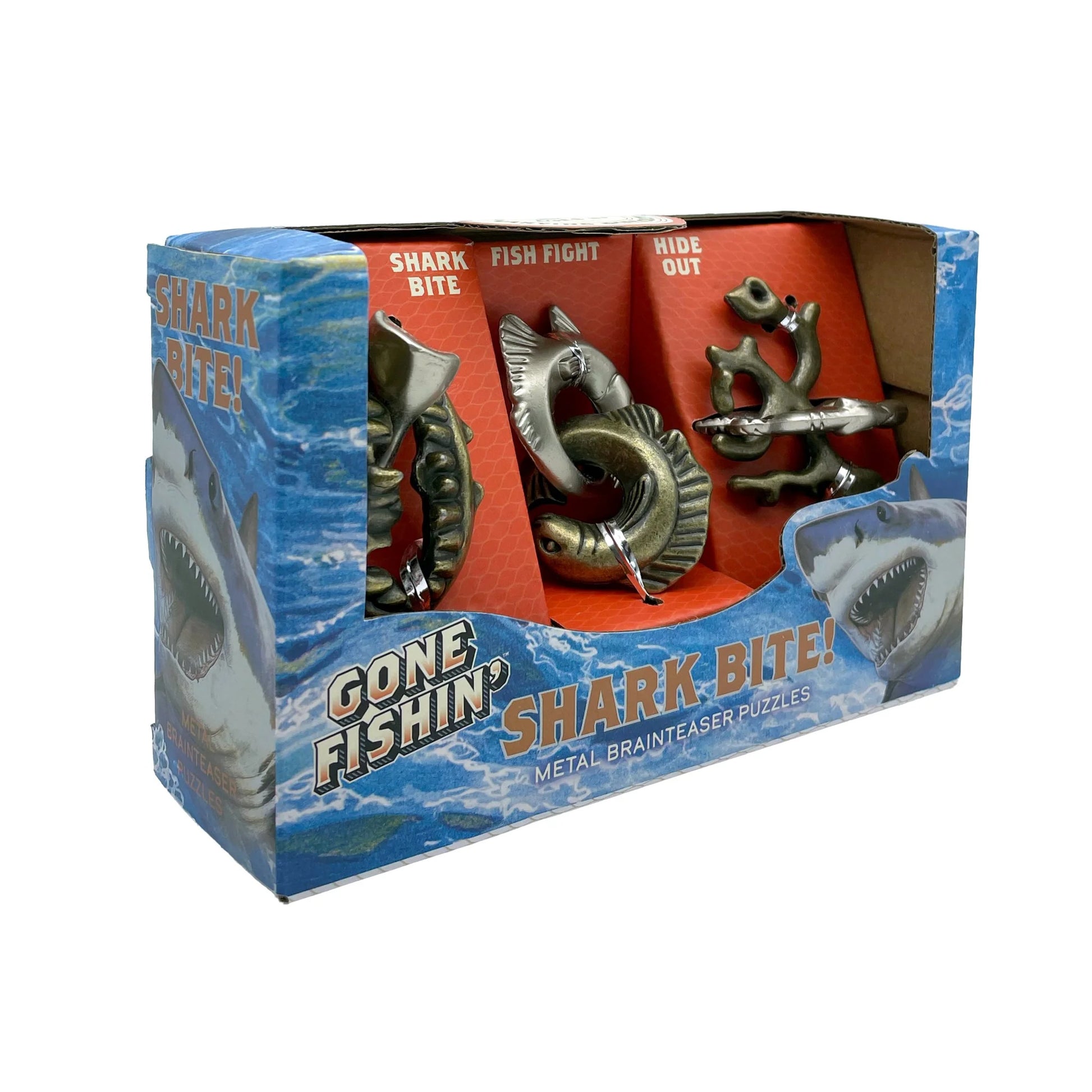 Gone Fishin' Shark Bite! metal brain teaser puzzles in retail packaging, showing three shark-themed metal puzzles inside a blue and orange box with shark graphics.