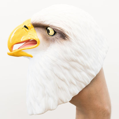 A realistic bald eagle head puppet shown on a person's hand against a plain light background.